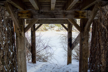 Old wooden structure overlooking snow 