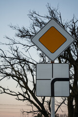 road sign the main road changes direction