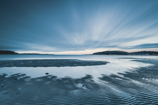 Coastal landscape at twilight outside Gothenburg with gentle waves and distinctive reflections