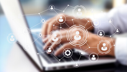 A modern workspace integrates digital tools and human elements, fostering collaboration among remote teams. The environment highlights flexibility, AI resources, and a focus on productivity