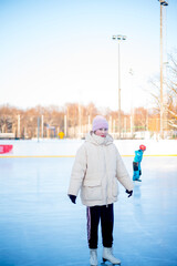 Winter fun, sports and vacation activities. Kids skating at the rink. Moscow Botanical Garden