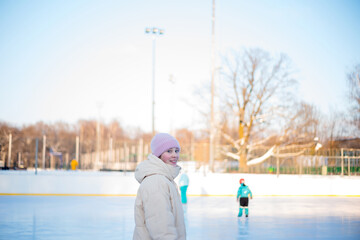 Winter fun, sports and vacation activities. Kids skating at the rink. Moscow Botanical Garden