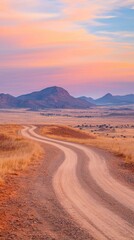 Fototapeta premium Winding dirt road through scenic landscape at sunset namibia outdoor panoramic travel inspiration