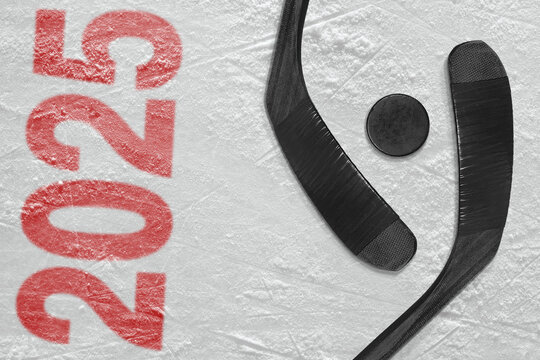 Puck and two sticks in a hockey arena