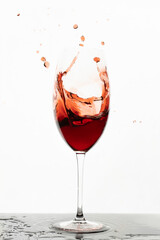 Splashes of red wine. Red wine in a glass. Clear wine glass. Isolated object.