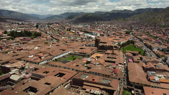 Aerial view of cusco city center with red tile roofs, highlighting the traditional architecture and