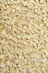 Composition with oatmeal flakes on gray background. Cooking breakfast