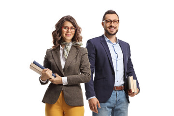 Male and female teachers standing and holding books