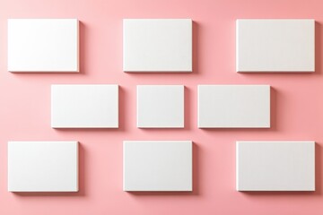 Fototapeta premium Minimalist arrangement of blank canvases on soft pastel pink background