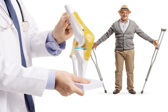 Doctor with a knee bone model and elderly male patient getting rid of crutches