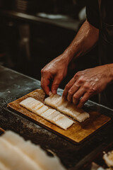 A photo of a sushi cheaf hands delicately preparing nigiri sushi Generative AI	