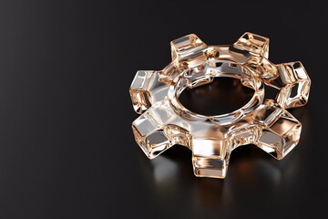 Unique glass gear shaped object resting on a dark surface, showcasing clarity and design intricacies