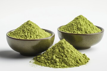 Matcha powder isolated on white background in small bowls displaying vibrant green color and fine texture