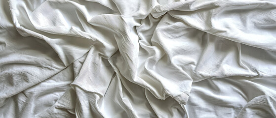 Soft, crumpled white fabric draped elegantly, creating a serene and minimalist aesthetic