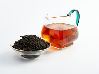 dry Chinese tea in a plate and next to it brewed in a teapot, photo on a white background