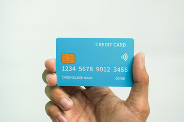 Hand holding credit card on white background for business and finance concept