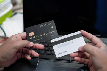 Woman holding credit card with two hands