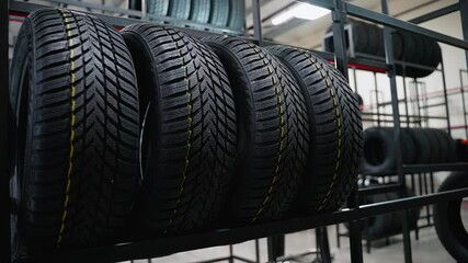 All-season tires on store rack with deep tread pattern
