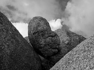 A boulder under the clouds in a black and white decor