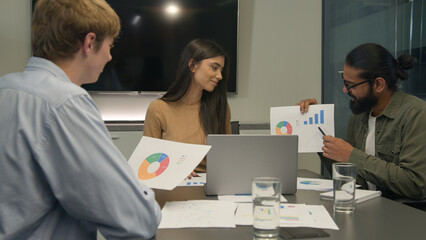 Obraz premium Team leader businessman coach showing corporate charts graphs on paper discuss analyze diagram graphic talk with colleagues diverse clients man woman listen business presentation at office conference