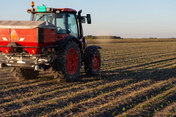 Tractor spreading artificial fertilizers