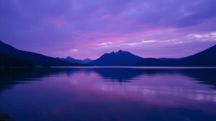Tranquil Lake with Majestic Mountains and Colorful Sunset Reflection