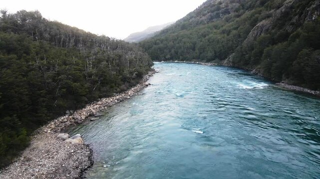 Drone footage of a river between forested hills in Rio Baker, Carretera Austral, Aysen Region, Chile