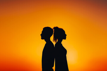 Silhouette of African American couple standing back to back against vibrant sunset sky, symbolizing unity, romance, and Valentine's Day themes, with a warm, tranquil ambience