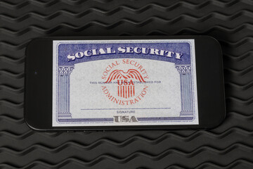 Social Security card blank on a smartphone. The Social Security Administration oversees retirement, disability, and survivors benefits.