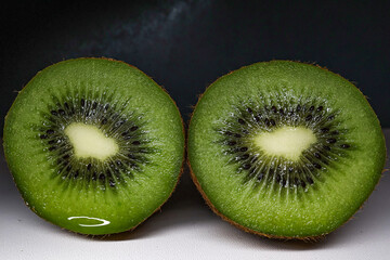 Two cut kiwi halves, close-up