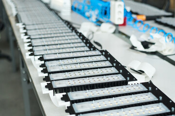 Row of new spare parts or other items produced by workers of modern factory on assembly line in workshop or plant