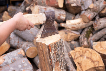The wood chopper sticks out in wooden hemp. Ax and ax handle.