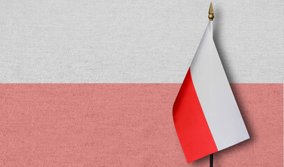 A small Poland flag with a faint image of the Poland flag in the background