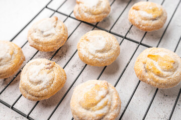 Italian cherry sugar cookies on a white plate. Powder sugar covered cookies.