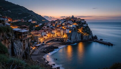 Fototapeta premium Scenic coastal village at sunset with warm golden lights reflecting on the calm sea creating a peaceful and picturesque Mediterranean seaside landscape