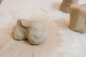 Potter is sculpting wet clay for ceramics products. Hands of a female potter making ceramic clay...