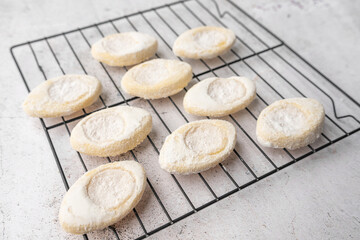 Italian lemon sugar cookies on a white plate. Powder sugar covered cookies.