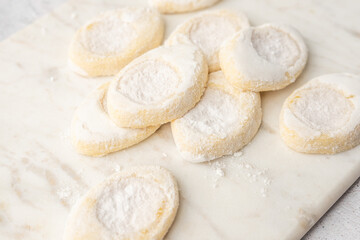 Italian lemon sugar cookies on a white plate. Powder sugar covered cookies.