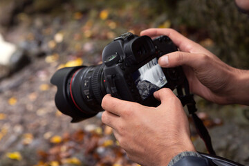 Photographer holding camera in nature