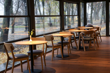 Stylish cafe with large windows and comfortable furniture. Interior design