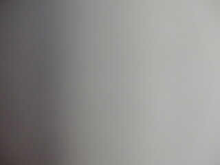gray bokeh with dark shadow on the left and lighter empty background on the right, graphic resource of blurred monochrome space grayscale, soft defocused design texture