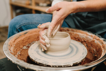 Potter creates a ceramic bowl in the pottery studio. Process of making a unique ceramic shape.