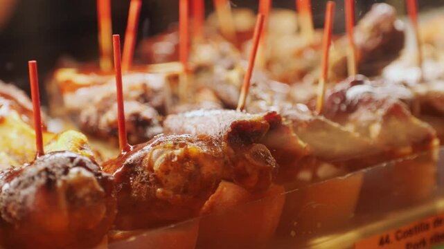 Italian or Spanish restaurant with traditional tapas pinchos food, Spanish cuisine, delicious tapas and cheese plate, bruschetta with cheese, olives dry tomatoes tasty sandwich bar appetizer, buffet