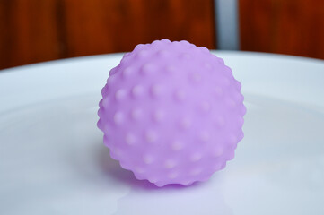hand holding sensory textured ball babies toddlers tactile stimulation sensory play early childhood...