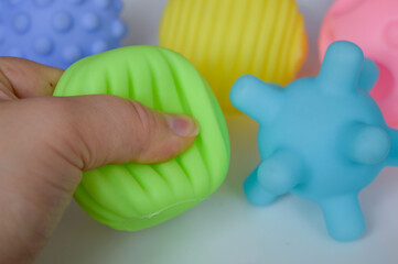 hand holding sensory textured ball babies toddlers tactile stimulation sensory play early childhood...