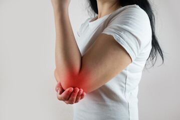 Woman having elbow ache at home, muscle pain due to lateral epicondylitis or tennis elbow. injury, Health and medical concept
