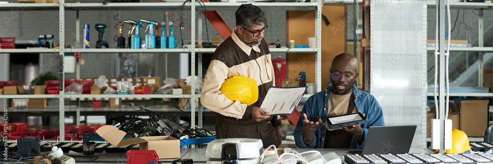 Leinwandbilder header of young male engineer with lamp and his boss with working documents discussing principles of