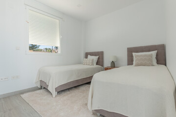 an image of two single beds in a Mediterranean bedroom for guests 
