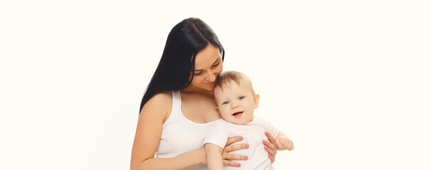 Happy smiling young mother playing with cute baby sitting together on the floor on white background