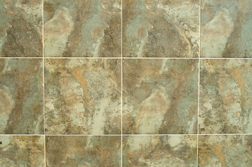 Colorful ceramic tiles imitating a stone wall closeup